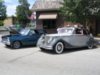 Blue Pontiac and a Grey Jaguar