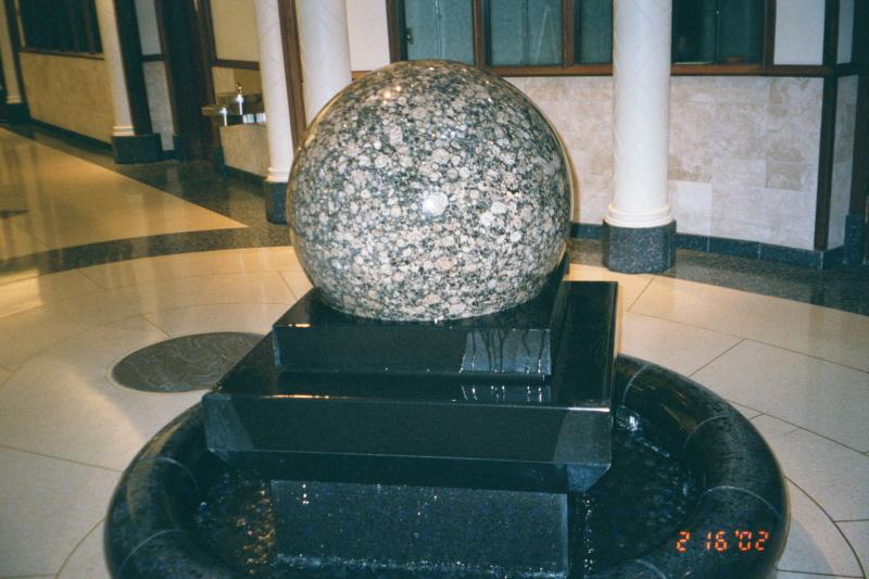 The granite ball rotates, spinning on a thin layer of water.
